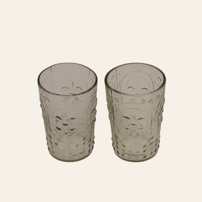 Two textured glass tumblers on a white background