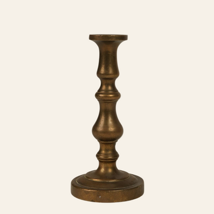 A small vintage brass candle holder with a classic turned design and a slightly aged patina.