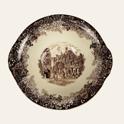 Decorative plate with vintage-style illustration of a village scene on a beige background