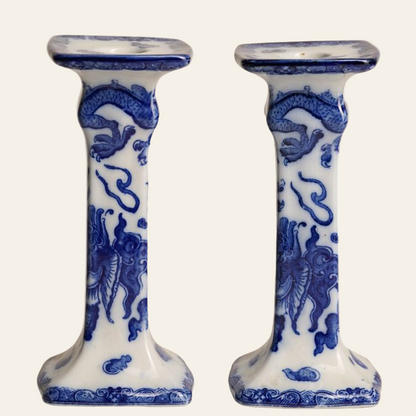A pair of Royal Doulton blue and white ceramic candlesticks with floral and dragon motifs.