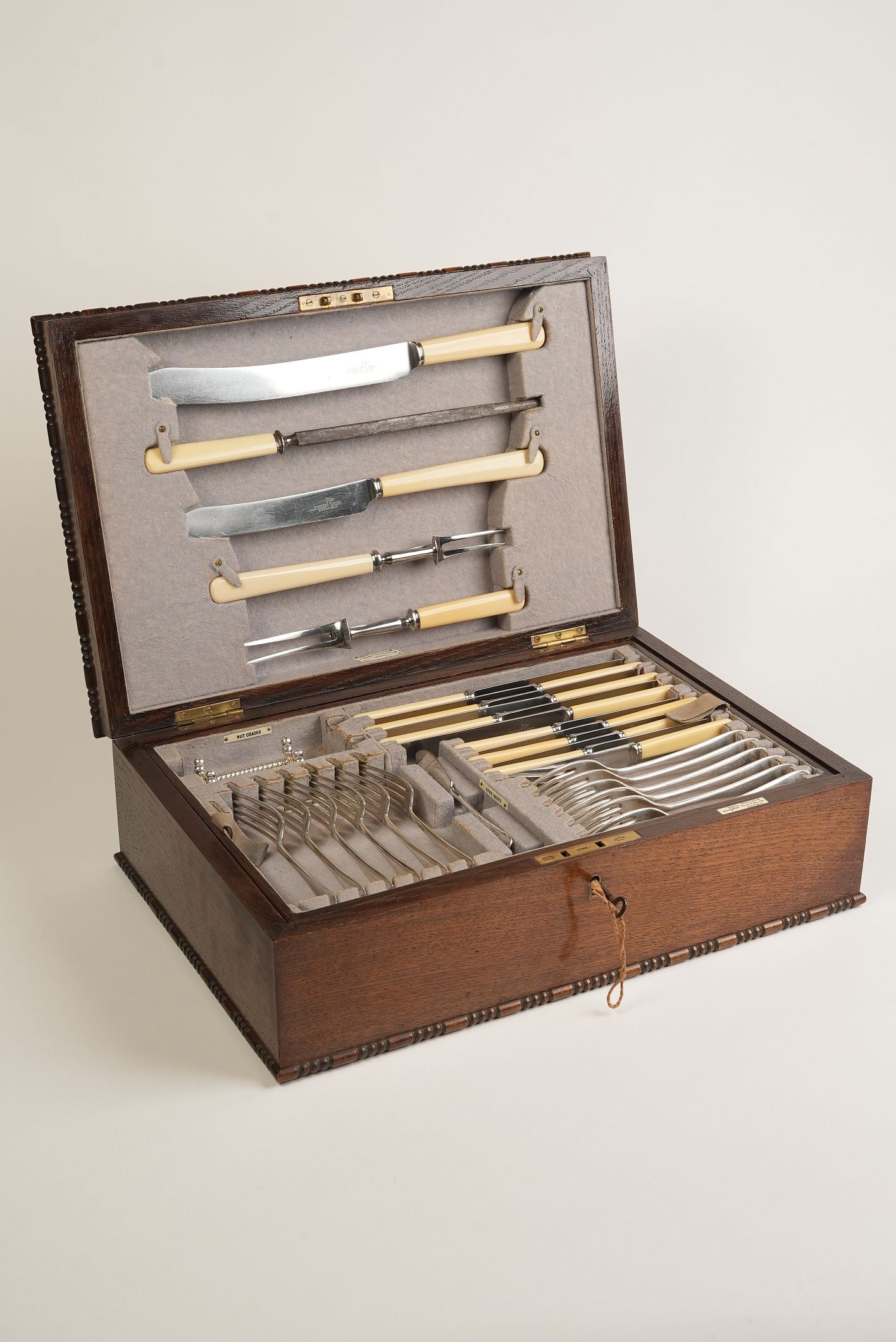 Set of knives in a wooden case on a light gray background