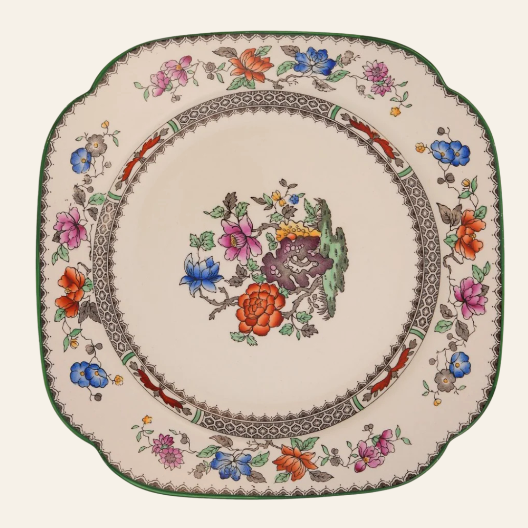 Decorative plate with floral patterns on a white background - authentic antique piece 