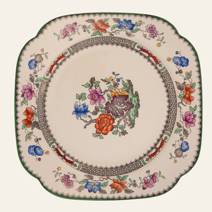 Decorative plate with floral patterns on a white background - authentic antique piece 