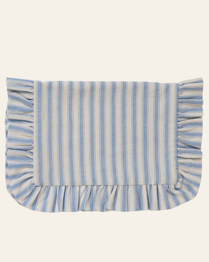 A rectangular table mat with blue and white stripes and a ruffled edge.