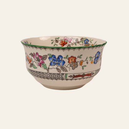A Copeland Spode Chinese Rose pattern sugar bowl with hand-painted floral designs and a scalloped green rim.