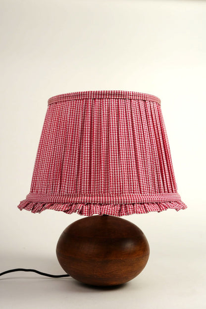 Lamp with a red checkered shade on a white background