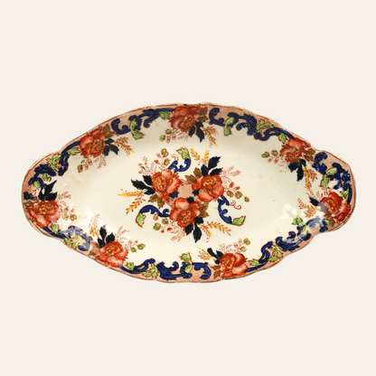A vintage John Maddock & Sons 'Majestic' pattern Royal Vitreous platter with bold orange roses, regal cobalt blue scrollwork, and elegant gold accents on a scalloped edge design.