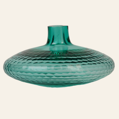 A round, emerald green glass vase with a honeycomb texture and a flared top.