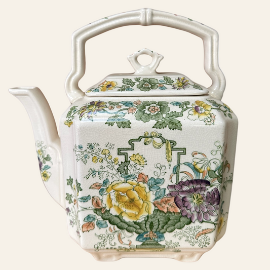 A Mason's Ironstone Strathmore Green teapot with a floral pattern in green, yellow, and other colors on a white background.