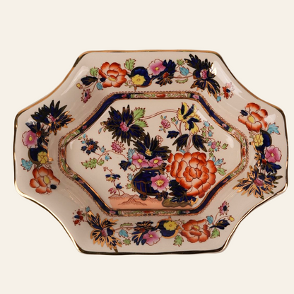 Antique octagonal serving dish with a floral pattern in shades of orange, gold, and other colors, with hand-painted gold accents around the edges.