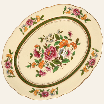 A vintage Royal Cauldon 'Ludlow' floral ceramic platter with a hand-painted floral motif and green and gold decorative border.