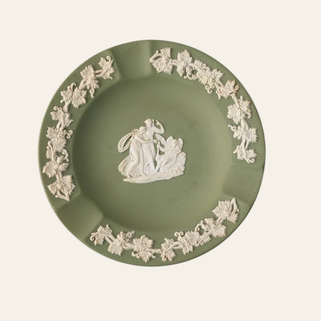 A vintage green Wedgwood ceramic ashtray with a classical scene and ornate border in white.