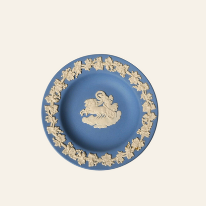 Decorative plate with gold embossed design on a blue background