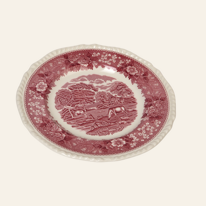 Decorative plate with red and white pattern on a white background