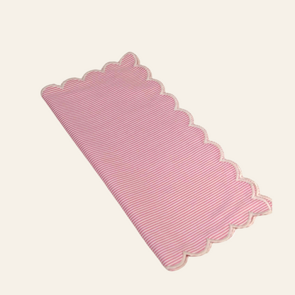 Pink scalloped mat on a white background
