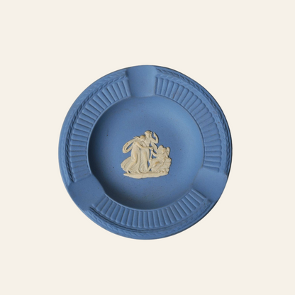 Blue ceramic ashtray with decorative design on a white background