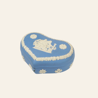 Heart-shaped blue box with white floral design on a white background
