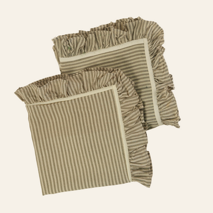 Two striped pillows with ruffled edges on a white background