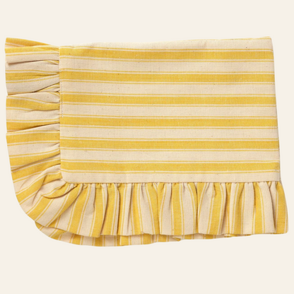 A rectangular placemat with a yellow and white stripe design and ruffled edges.