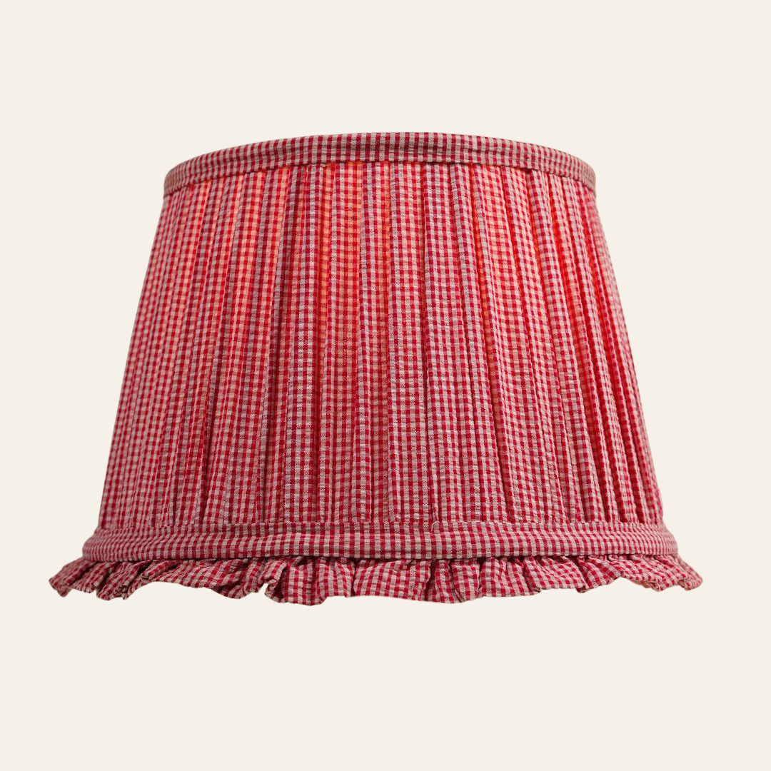 Red and white checkered lampshade with ruffled edge on a beige background