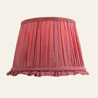 Red and white checkered lampshade with ruffled edge on a beige background