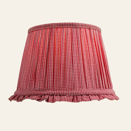 Red and white checkered lampshade with ruffled edge on a beige background
