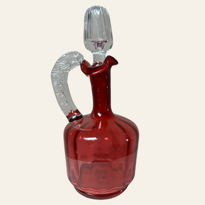 Red glass decanter with silver handle and stopper 